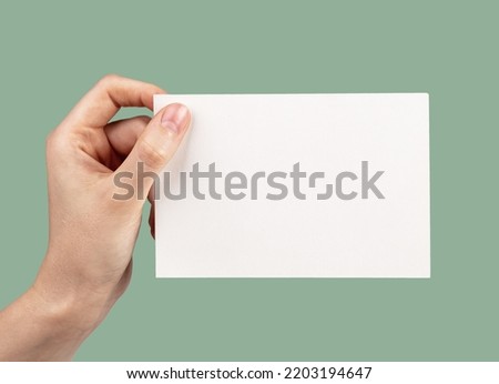 Hand holding card mockup on eco green background. Brochure, flyer template with information about nature, ecology, Earth protection. High quality photo