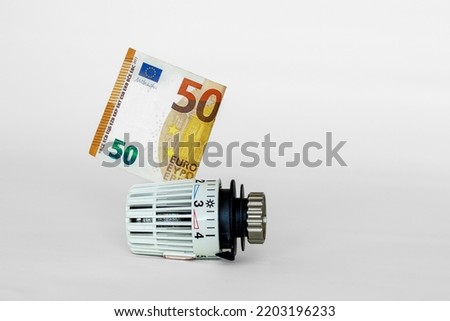 Thermostat for saving money and gas for heating Royalty-Free Stock Photo #2203196233
