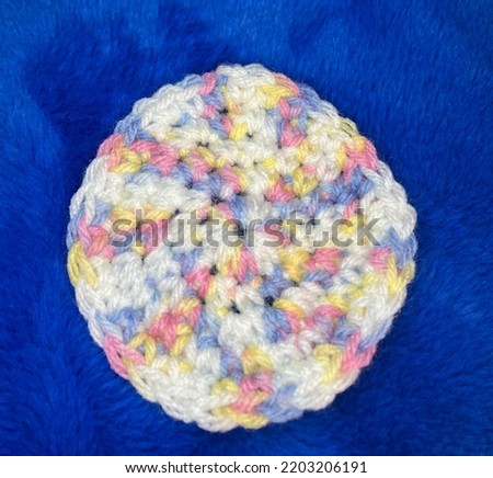 Round “Unicorn-Swirl” Crochet Coaster on Royal Blue Background
