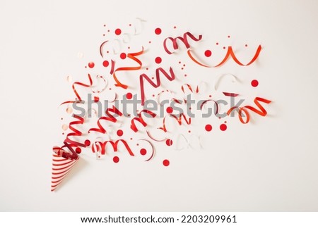 striped birthday hat with confetti on white background Royalty-Free Stock Photo #2203209961