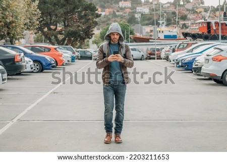 man walking with mobile phone and backpack in the city street, travel and tourism