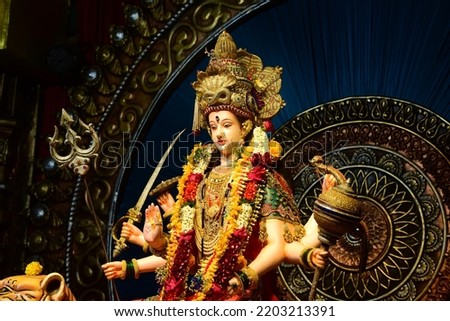 Goddess Durga idol at decorated Navratri festival pandal. Royalty-Free Stock Photo #2203213391