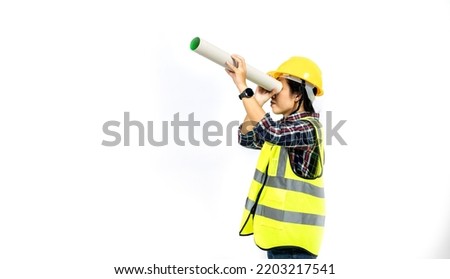 Young woman shining paper roll with a smile in a vest and hard hat on white background. Construction concept, new building. Banner.