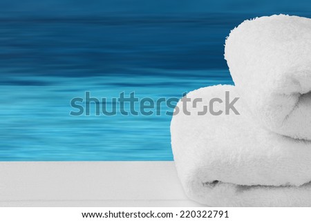 Spa, relax, balneo - towels on wooden desk with blue water - sea background