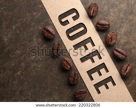 Coffee crop beans with paper and text on wood texture background