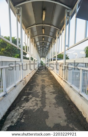 Empty pedestrian bridge in the morning Royalty-Free Stock Photo #2203229921
