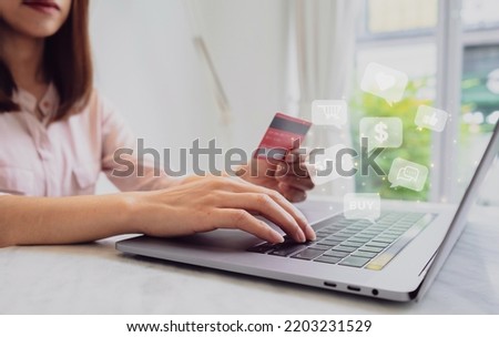Woman hand holding credit card and using laptop at cafe for paying online using internet banking service. Online shopping concept