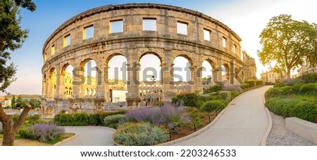 Panorama medieval Ancient Roman Amphitheater in Pula at dawn, Croatia. Architecture and landmark of Croatia. Travel concept background. Royalty-Free Stock Photo #2203246533