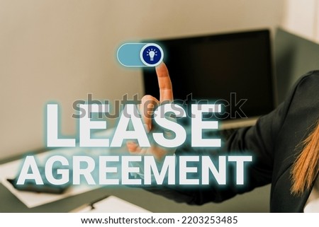 Hand writing sign Lease AgreementContract on the terms to one party agrees rent property. Internet Concept Contract on the terms to one party agrees rent property