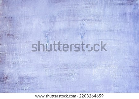 Chaotic strokes of paint on a wooden surface as a background