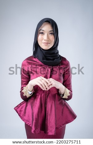 Portrait of a beautiful Muslim female model wearing hijab, a lifestyle apparel for Muslim women isolated on white background.Modern hijab fashion concept.