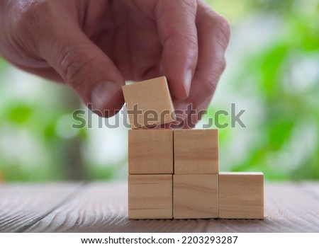 Hand holding empty wooden blocks with customizable space for text or ideas. Copy space.