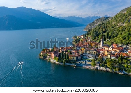 Village of Varenna on Como lake in Italy. Varenna by Lake Como in Italy, aerial view of the old town with the church of San Giorgio in the central square. Famous mountain lake in Italy Royalty-Free Stock Photo #2203320085
