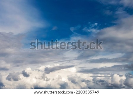 Autumn cloudy blue sky background. Panoramic view with beautiful clouds. Horizontal cloudscape. High-resolution photography. Design element. Copy space.