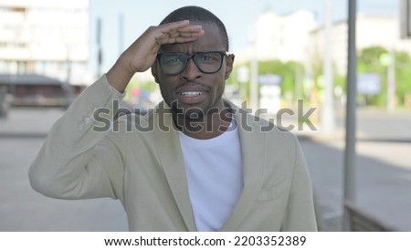 African Man Looking Around for Opportunity Outdoor