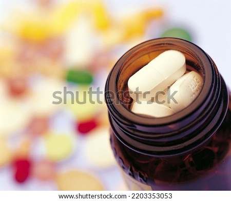 White medical pills and tablets drug bottle. Macro top down view.