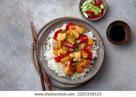 Sweet ad sour chicken with steamed rice, top view Royalty-Free Stock Photo #2203358523