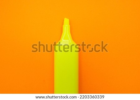 neon yellow highlighter on yellow background Royalty-Free Stock Photo #2203360339