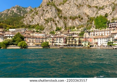 The beautiful Garda lake in Italy, seen from onboard a tourist ferry. It is a beautiful summer day, with just a little bit of clouds.