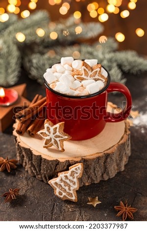 Red mug of hot cocoa with marshmallows and homemade Christmas gingerbread cookies. Christmas vertical card with hot cocoa and golden bokeh