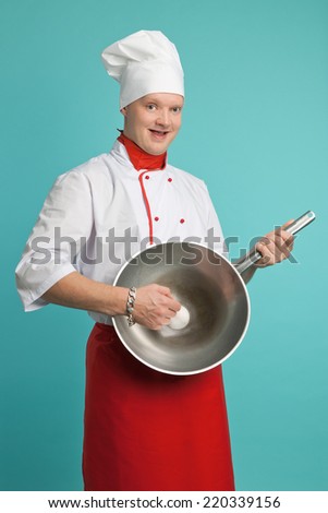 The man in the suit chef holding a frying pan