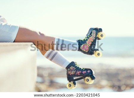Relax roller skate woman legs at beach, ocean harbor or sea water with holiday fun, freedom and adventure travel. Feet of sports athlete or skater girl with skating shoes for summer outdoor journey