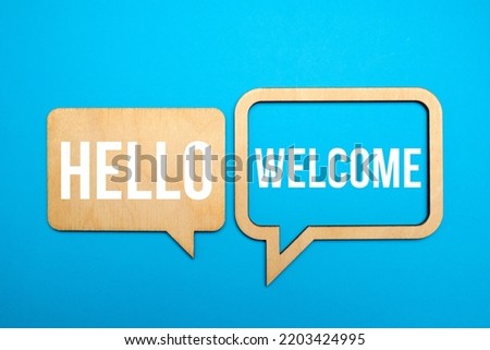Hello and welcome symbol. Concept words Hello and welcome on wooden speech bubbles. Business hello and welcome concept. Copy space.