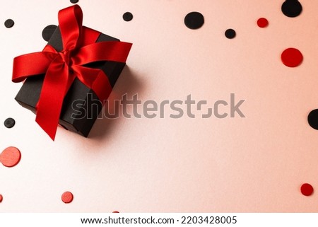 Composition of present and colourful spots on white background. Retail, shopping and black friday concept.