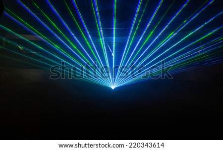 Disco light show, Stage lights with laser Royalty-Free Stock Photo #220343614