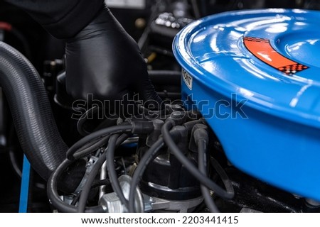 Ignition apparatus and air filter in a classic car. Royalty-Free Stock Photo #2203441415