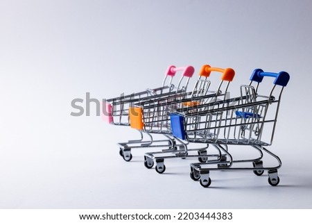 Composition of shopping carts and copy space on white background. Retail, shopping and black friday concept.