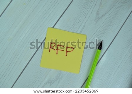 Concept of RFP - Request For Proposal write on sticky notes isolated on Wooden Table.
