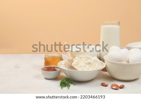 Kitchen background for baking and cooking cake,bread,confectionery and ingredients for cooking,milk,honey,flour,salt,sugar,eggs and cream on pastel background with place for text,selective focus,