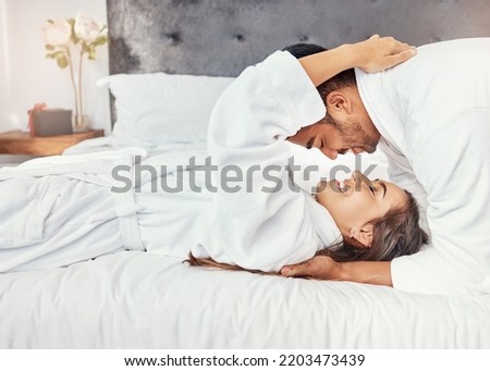Couple holiday, hotel bedroom and happy on luxury vacation for wedding celebration, smile for love on bed and happiness hug together in house. Man and woman relax with romance in house apartment Royalty-Free Stock Photo #2203473439