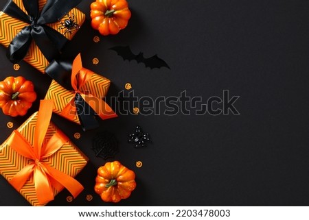 Happy Halloween holiday background with gift boxes, orange pumpkins, spiders, bats, confetti on black table. Halloween sale, discount, promotion banner design.