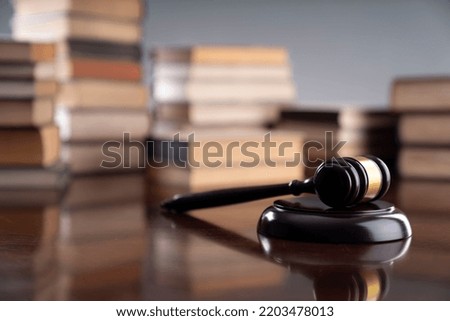 Judge's gavel surrounded by books.
