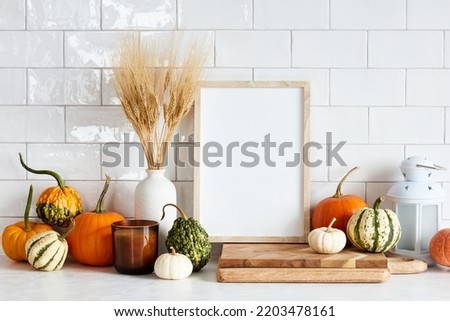 Autumn still life. Picture frame template, harvest of pumpkins, dry wheat on white table in scandinavian kitchen interior. Autumn fall, Harvest, Thanksgiving holiday concept.