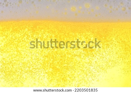 Golden beer and rising bubbles