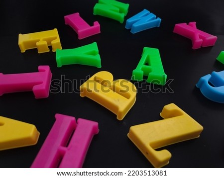 Close up of colorful alphabets on black background perfect for children's education