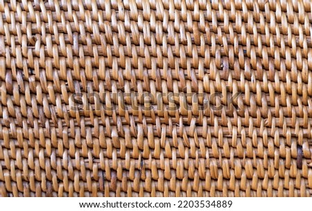 The background of brown rattan weaving is a detailed work. Exquisite that requires skilled technicians because it takes a long time to produce. Technicians need patience. abstract art background.