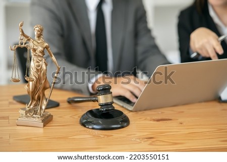 A female lawyer is consulting with a team in the office to resolve the issue Lawyer Fight for Freedom of Her Client with Supporting Evidence