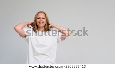 girl in white t shirt smiling isolated on grey