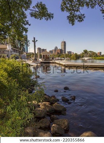 Portrait of Boston in Massachusetts, USA showcasing the Charles River and one of its marinas on a warm summer day.