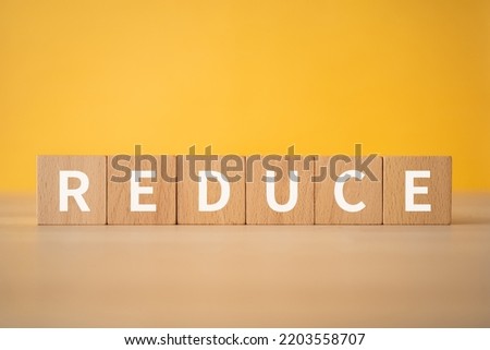 Wooden blocks with "REDUCE" text of concept.