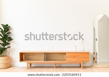 White color wall Background, minimal living room interior decor with a TV cabinet. Royalty-Free Stock Photo #2203560411