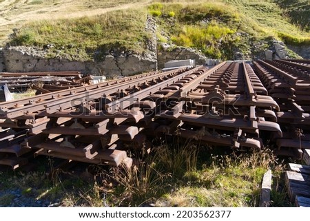 Stacked railway tracks of small gauge cog wheel railway at Swiss mountain pass Furkapass on a sunny late summer morning. Photo taken September 12th, 2022, Furka Pass, Muttbach, Switzerland.