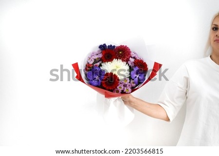 beautiful bouquet of flowers in the hands of a woman. photo for a postcard and catalog of an online flower shop. fresh flower delivery