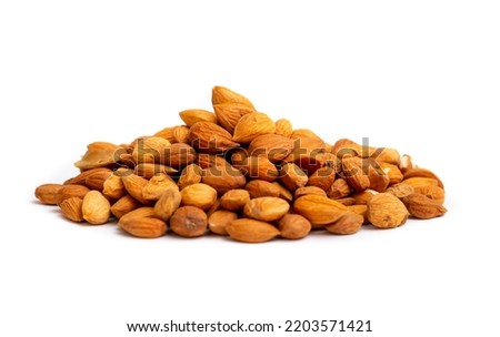 Apricot kernels peeled close-up as a background. Apricot grains heap isolated on white background. Royalty-Free Stock Photo #2203571421