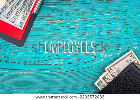 EMPLOYEES - word (text) and money dollars on the table in a notebook, wallet. Business concept, buying goods and products, paying for services (copy space).
