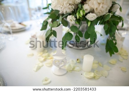 Sign showing table number at wedding party.